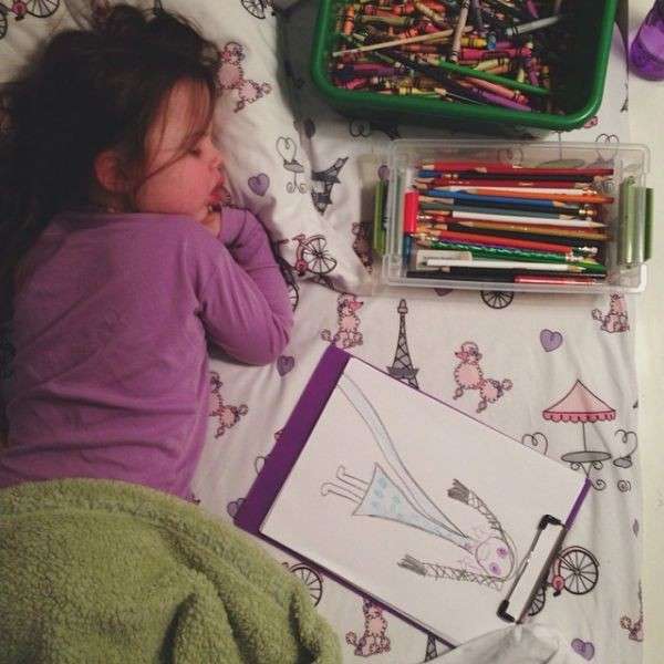 Маленькая девочка рисовала и уснула